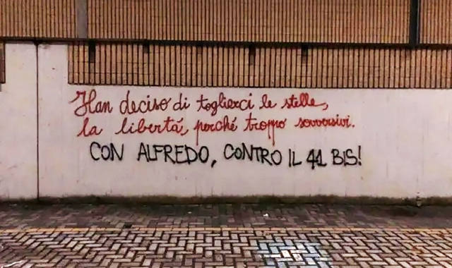 Una delle scritte tracciate sul muro esterno del cimitero (Foto Blitz)