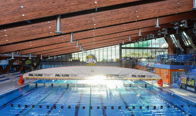 In alto, la vasca della piscina Manara di Busto Arsizio. Qui sopra, un bagnino veglia sugli utenti (Blitz)